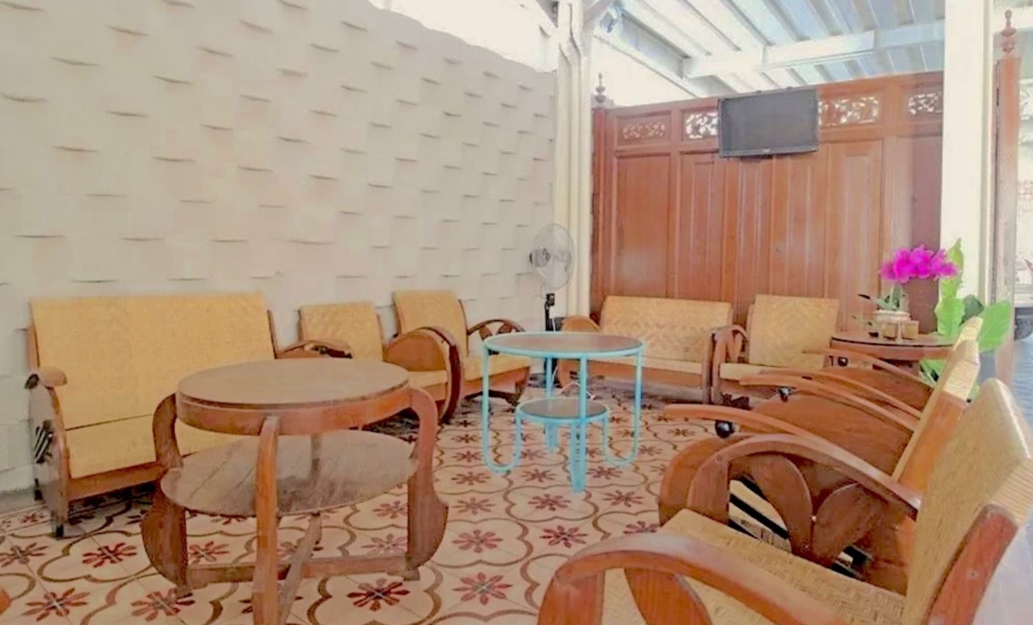 A cozy seating area with wooden furniture and a patterned floor.