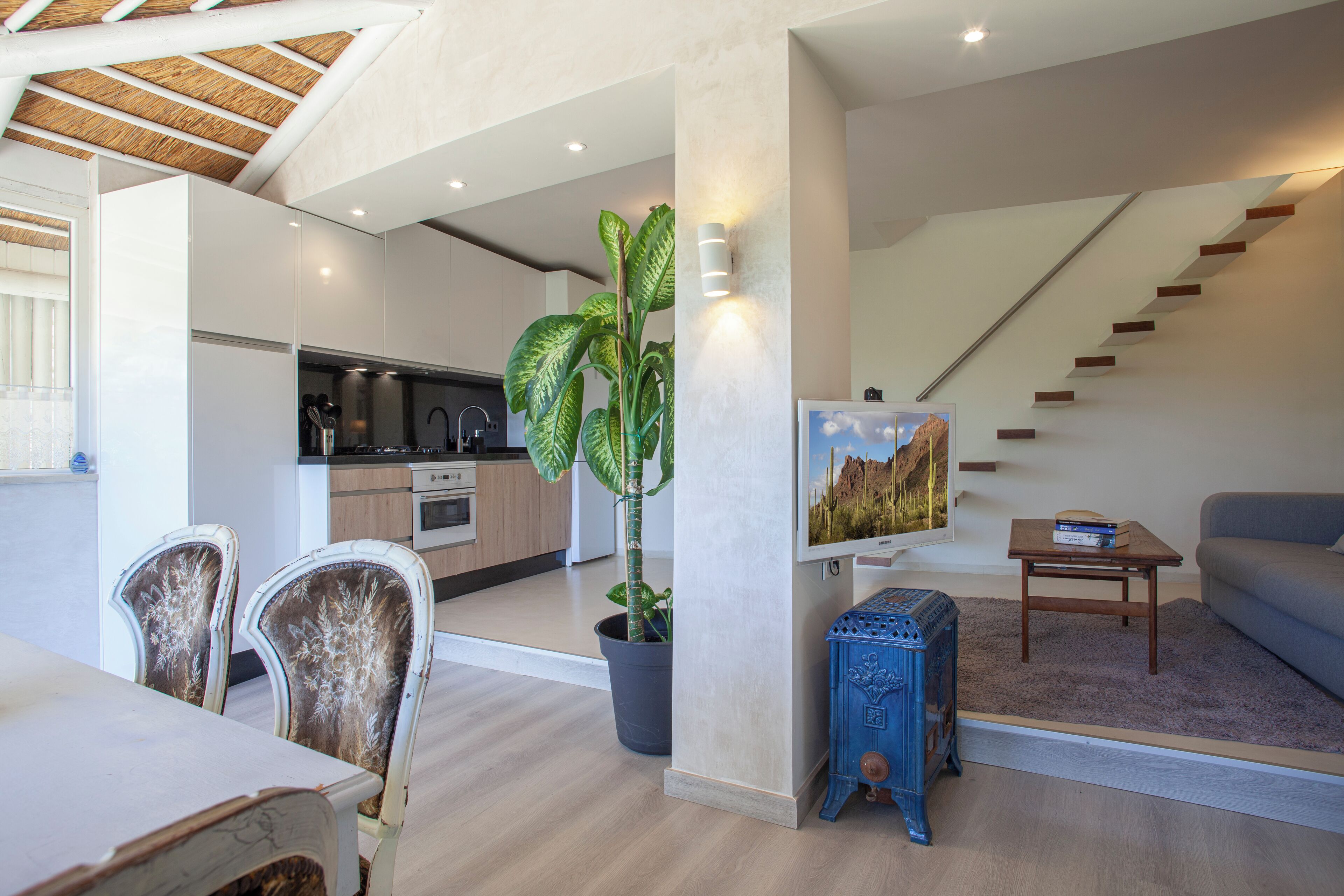 A modern apartment with a kitchen, dining area, and living room.