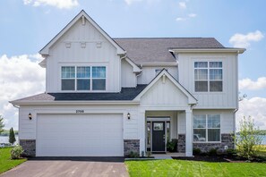 A two-story house with a garage, a front door, and a driveway. - 2708 Harbor Court (Delavan)