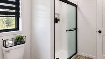 A modern bathroom with a toilet, a shower with a glass door, and a window with blinds.