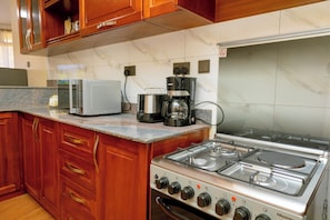 Family Apartment, Hill View | Private kitchen | Microwave, stovetop, cookware/dishes/utensils - Sand Grains Residences 012 (Entebbe)