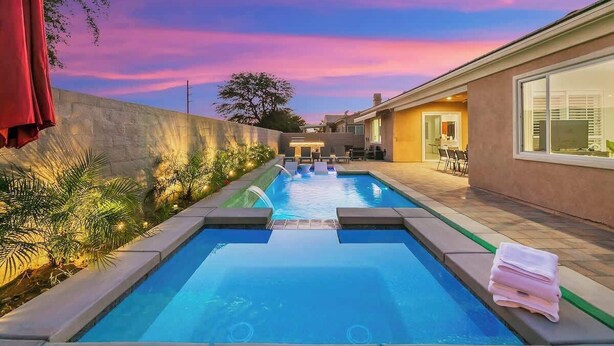 A swimming pool with a view of a house and a sunset. - Lakeside Escape: Game Room W/ AC (Indio)