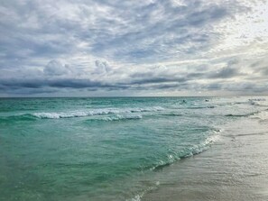 A beach with turquoise waters and a cloudy sky. - Stay a While - 3 min walk to private beach access!

 (Destin)
