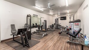 A gym with various exercise equipment, mirrors, and motivational posters on the walls. - Recliners! Large Az Room - Adult 55+ Activities Galore! (Mesa)