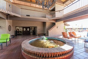 A courtyard with a central fountain, outdoor seating, and a reception area. - Recliners! Large Az Room - Adult 55+ Activities Galore! (Mesa)