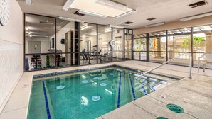 An indoor swimming pool with clear water, glass walls, and a view of the outside. - Recliners! Large Az Room - Adult 55+ Activities Galore! (Mesa)