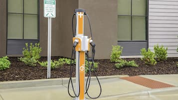 An electric car charging station with a sign indicating it is for electric cars only while charging.