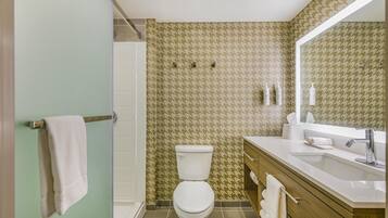 A bathroom with a toilet, sink, and vanity.