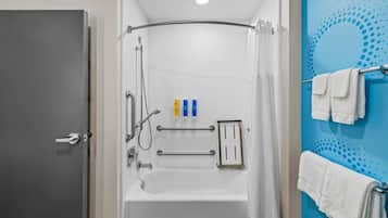 A modern bathroom with a bathtub, shower, and towel rack.