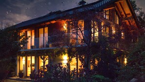 A two-story house with a balcony, large windows, and a well-lit exterior. - Black Forest Loft 1, Unique Home, View (Horben)