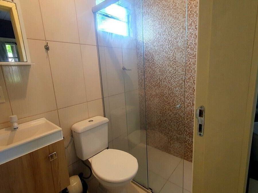 A bathroom with a toilet, sink, and shower.