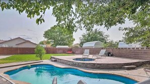 A backyard with a swimming pool, a hot tub, and a patio area with lounge chairs. - Massive Backyard with Private Pool and Spa (Hurricane)