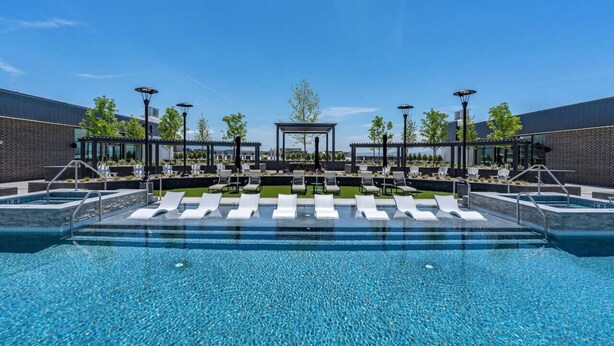 A swimming pool with lounge chairs and a covered seating area. - Amazing Deluxe 2BR Pool/Gym/Htub (Salt Lake City)