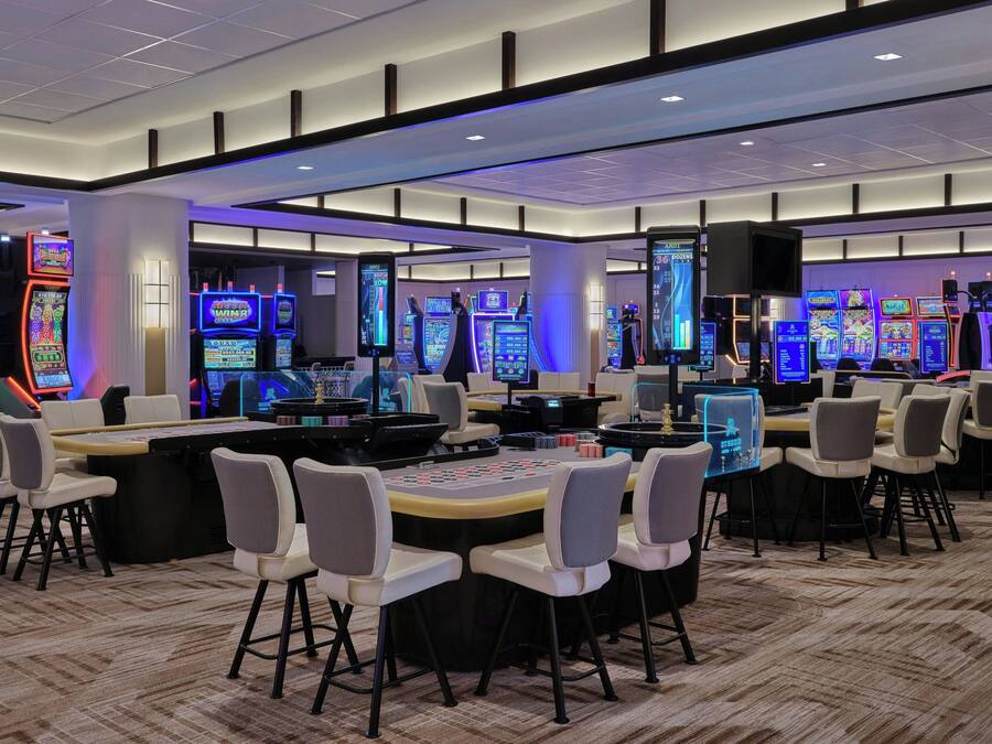 A casino with multiple gaming tables and slot machines.