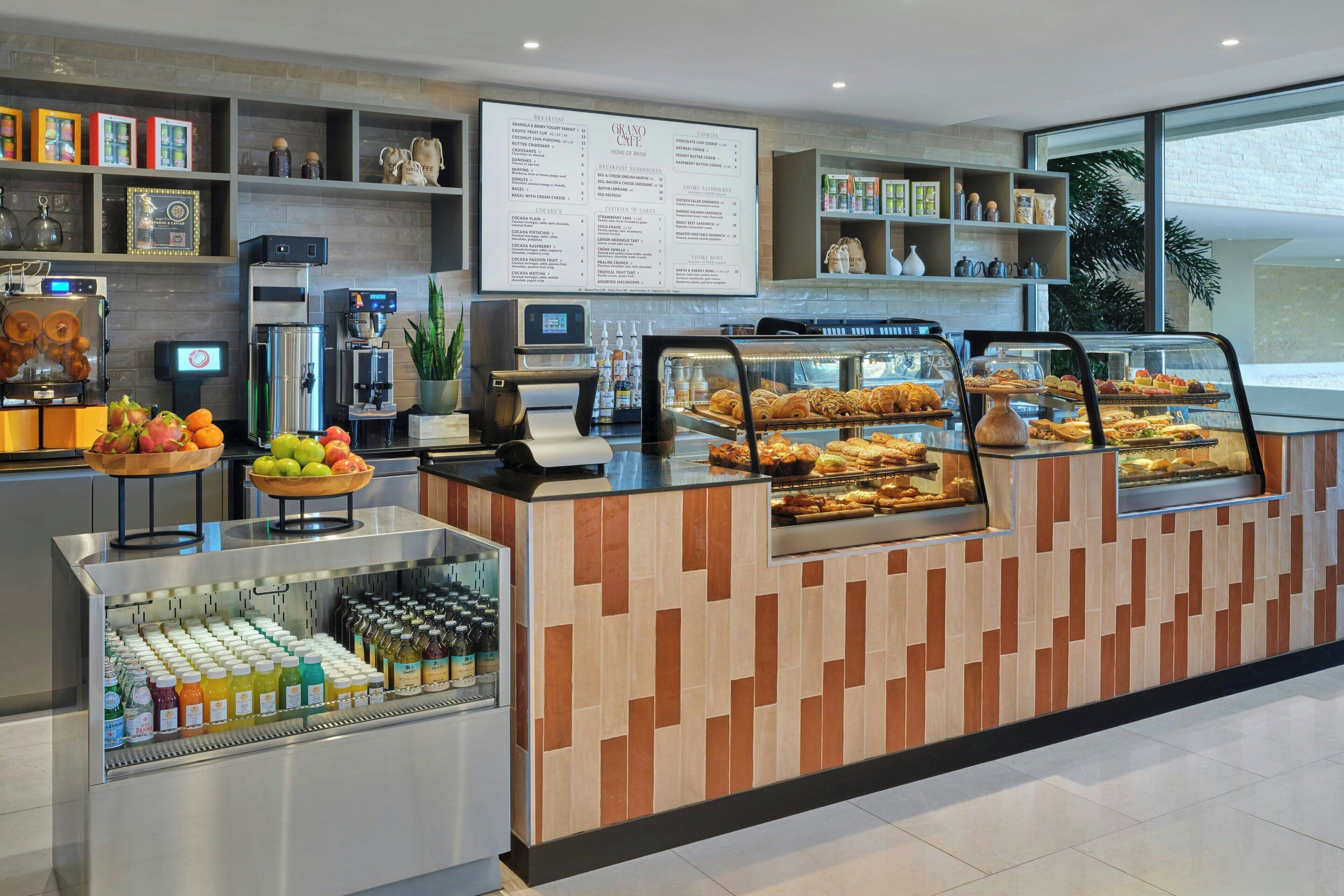 A breakfast bar with a variety of pastries and a selection of juices and bottled water.