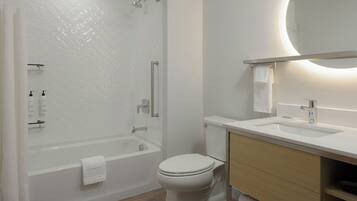 Un baño moderno con ducha, inodoro y lavamanos.