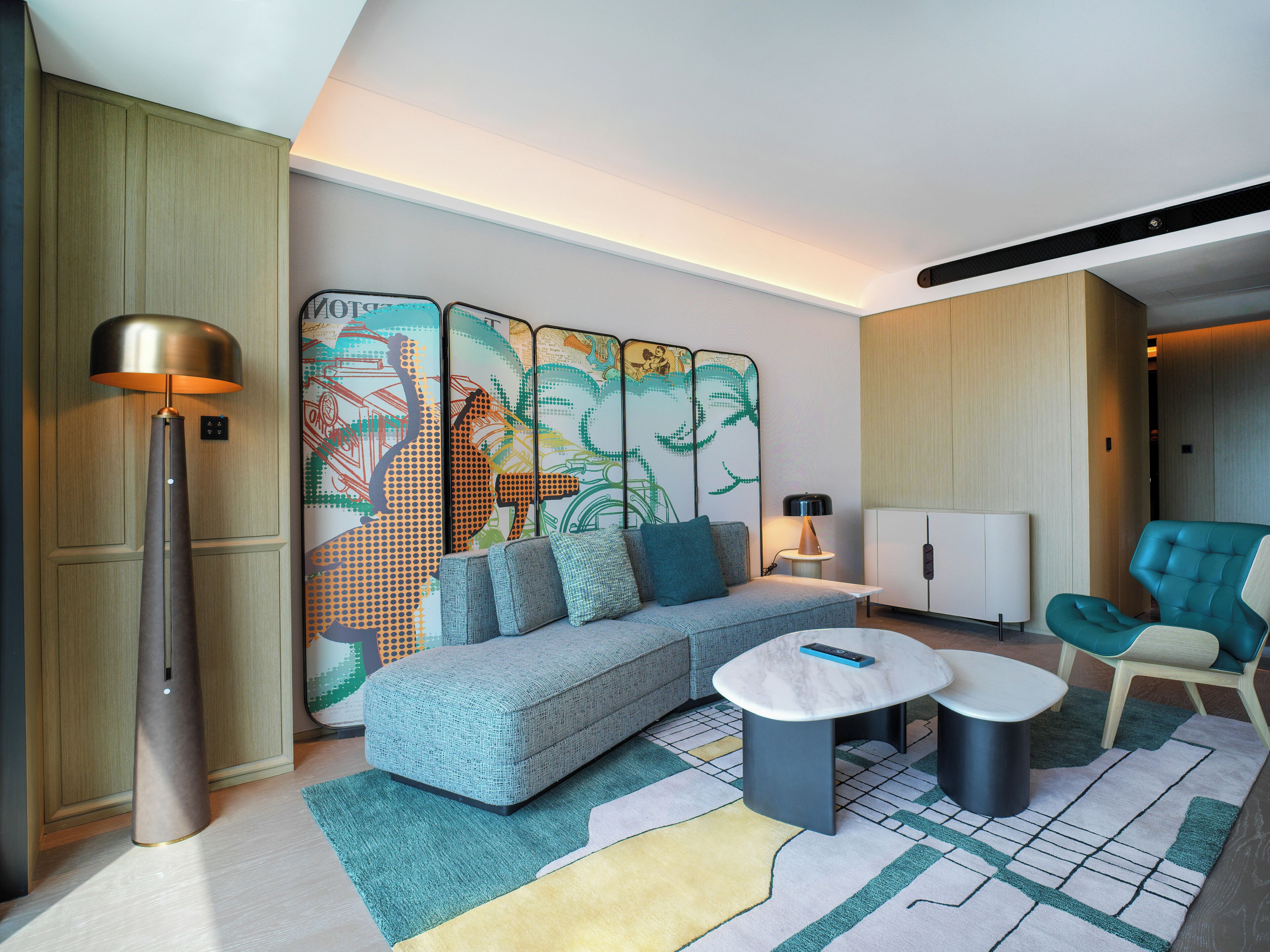 A modern living room with a sectional sofa, a round coffee table, and a floor lamp.