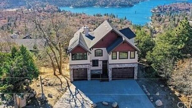 A two-story house with a garage, surrounded by trees and a lake view. - Above It all (Lake Arrowhead)