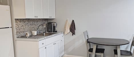Fridge, microwave, coffee/tea maker, cookware/dishes/utensils