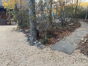 A gravel driveway leading to a stone pathway.