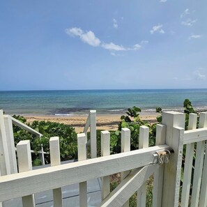 A beach view with a wooden fence in the foreground. - Font Beach Villa w/ Private Pool (Aguada)