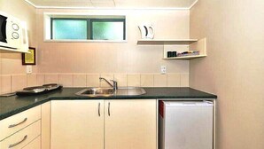 Family Triple Room, City View | Private kitchen | Fridge, microwave, dining table