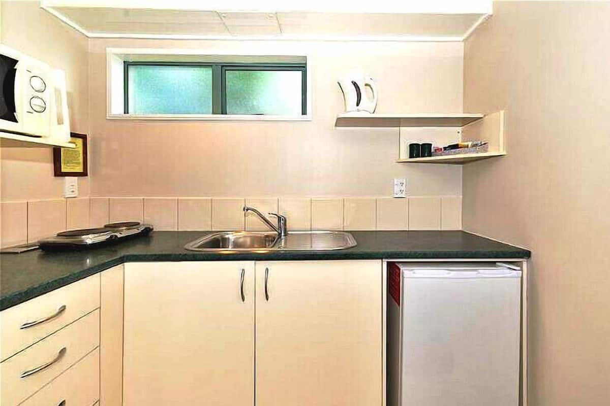 Family Triple Room, City View | Private kitchen | Fridge, microwave, dining table
