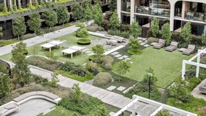 A modern building with a rooftop garden, outdoor seating areas, and a well-maintained lawn. - luxury apartment with water views. Walking distance from beach (Port Melbourne)