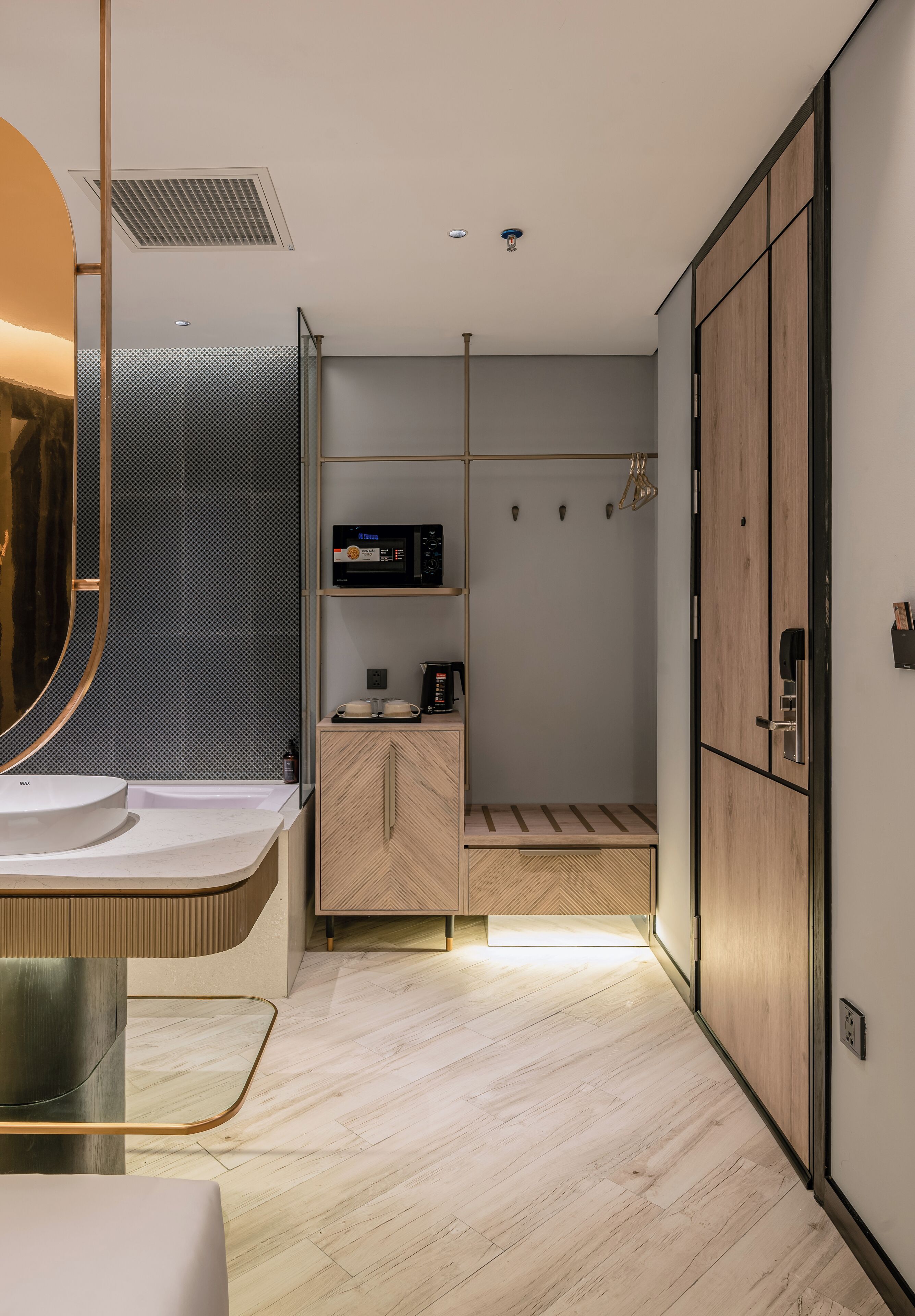 A modern bathroom with a large mirror, a sink, a shower area, and a wooden cabinet.