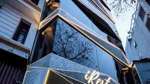 A building with a modern design, featuring a prominent 'iRest Signature' sign above the entrance. - iRest Signature Ba Dinh Lakeside (Hanoi)