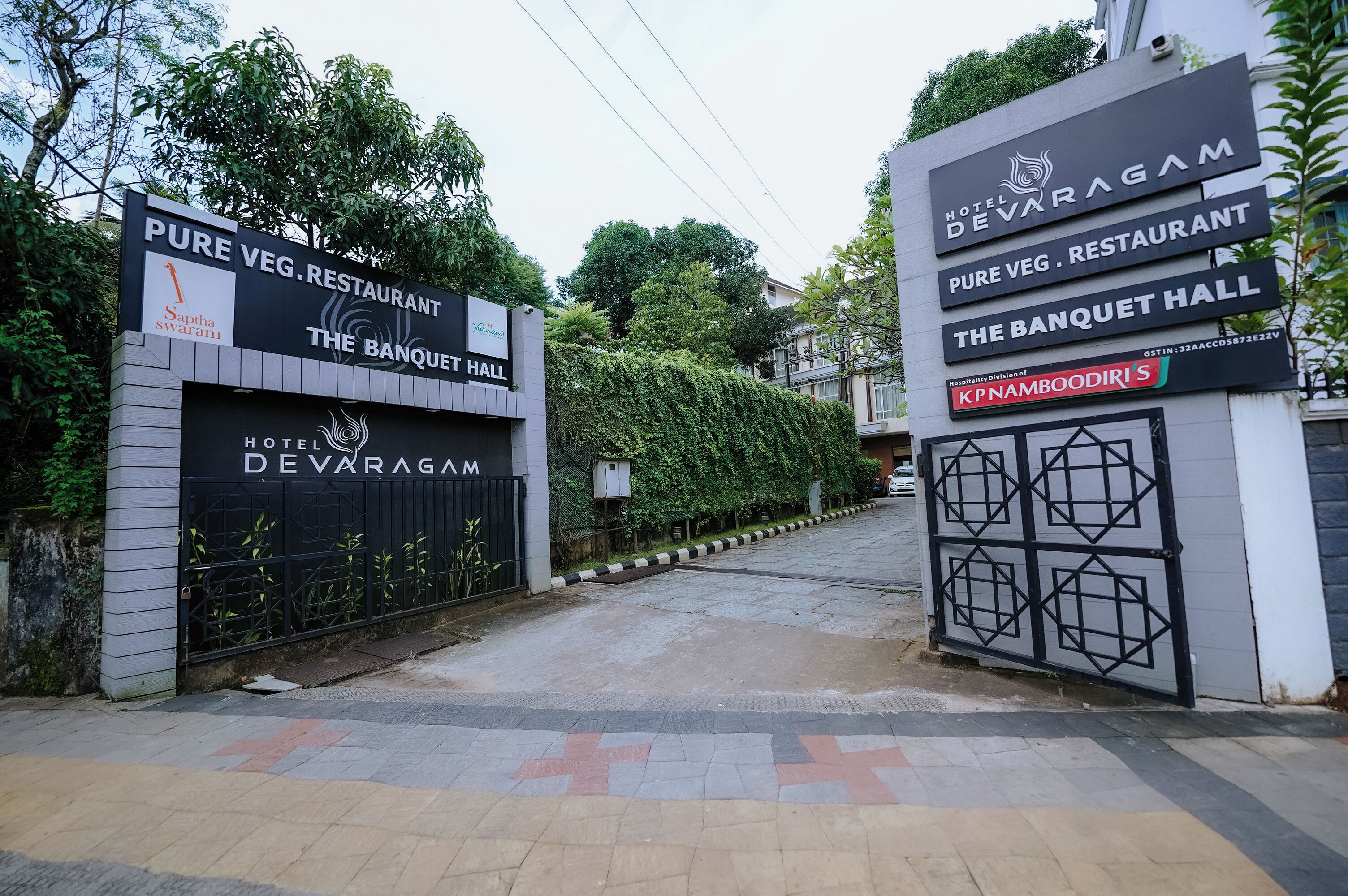 The entrance to Hotel De Varagam with signs for Pure Veg. Restaurant and The Banquet Hall.
