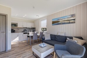 Un espace de vie moderne comprenant un canapé, une table basse et une table à manger.