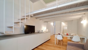 A modern living space with a kitchen area, dining table, and a sofa. - MILAN design Loft in great location (Milan)