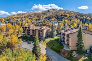 Aerial view of the condo building nestled right in the slopes—true ski-in/ski-out access with mountain charm all around.