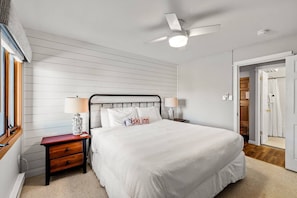 Primary bedroom with a king bed and bathroom just steps across the hall for convenience.