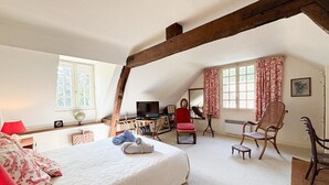 A bedroom with a large bed, a television, a desk, and a chair. - La maison des tilleuls with swimming pool for 8 people (Saint-Sulpice-sur-Risle)