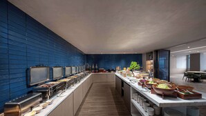 A buffet setup with various food stations and a long counter. - Days Hotel by Wyndham Renhuai Canglong (Zunyi)