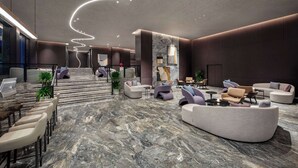 A modern lobby with a marble floor, seating areas, and a staircase. - Days Hotel by Wyndham Renhuai Canglong (Zunyi)