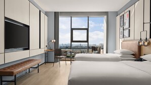 A modern hotel room with a large window, a flat-screen TV, a desk, and two beds. - Four Points Datong Pingcheng (Datong)