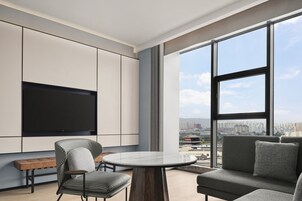 Executive Suite, 1 King Bed, City View | Living room | 55-inch Smart TV with digital channels