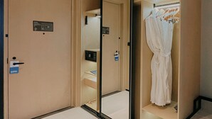 A hotel room with a large mirror, a wardrobe, and a small desk with a computer. - Four Points Datong Pingcheng (Datong)