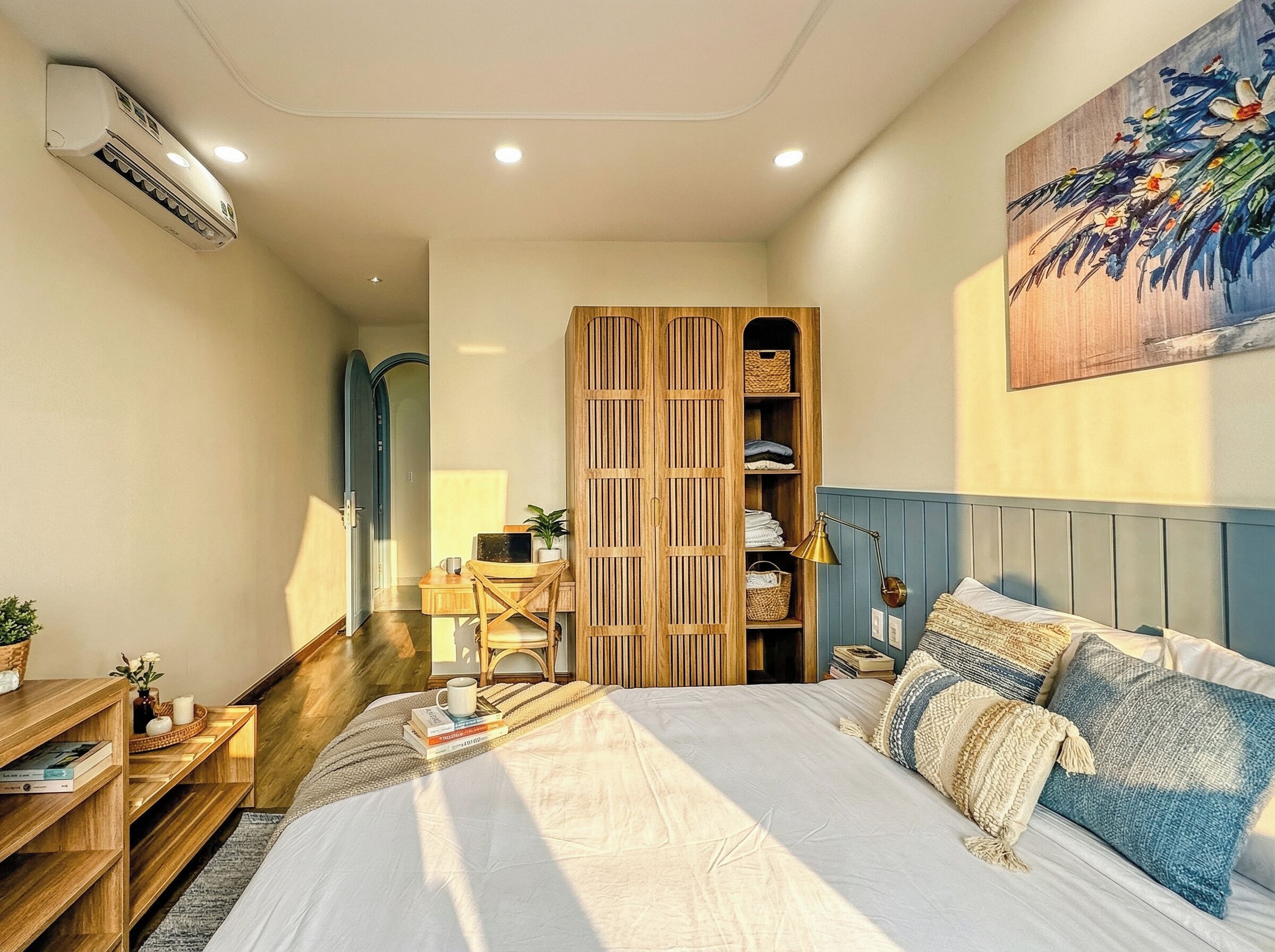 A bedroom with a bed, bedside tables, a wardrobe, and a desk with a chair.