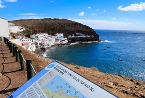 Enjoy breathtaking views of the coastline from this picturesque spot, where a hill meets the sea and a charming settlement unfolds.