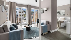 A modern living room with a sofa, a coffee table, and a bed. - "Arriving" in the heart of St. Peter-Ording (Sankt Peter-Ording)
