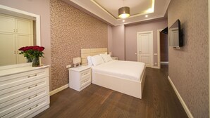 A bedroom with a bed, nightstands, a dresser, a mirror, and a TV. - Mount Ararat View 2-bedroom Luxury Apartment by Sweet Home (Yerevan)