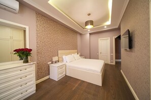 A bedroom with a bed, nightstands, a dresser, a mirror, and a TV. - Mount Ararat View 2-bedroom Luxury Apartment by Sweet Home (Yerevan)