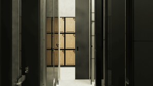 A hallway with lockers and a door leading to a room. - Volbs (Tabanan)