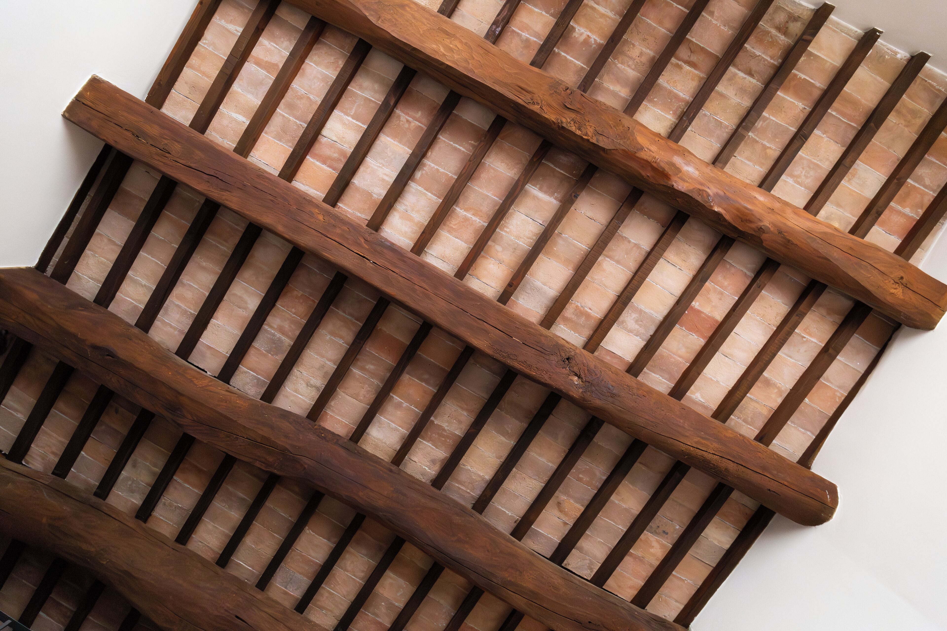 A close-up of a wooden slat wall with a brick pattern.