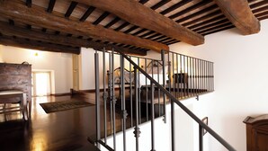 A wooden staircase with a metal railing, leading to an upper floor. - Raffaello  (Perugia)