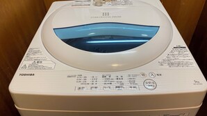 A white Toshiba Star Crystal Drum washing machine with a transparent water tank, control panel, and safety instructions. - W311 Tokyo Monthly rental- Sakurashinmachi Sunrise (Setagaya City)